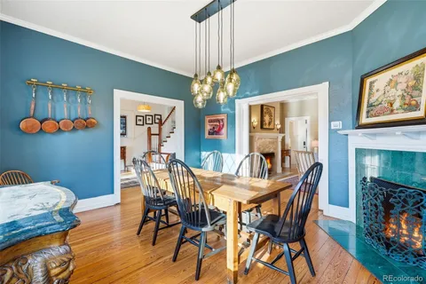 a view of a dining room with furniture a chandelier and wooden floor