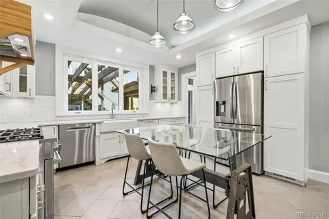 a kitchen with stainless steel appliances granite countertop a stove a refrigerator and a stove top oven