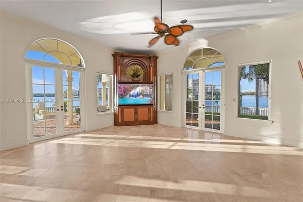 a view of a room with wooden floor and windows