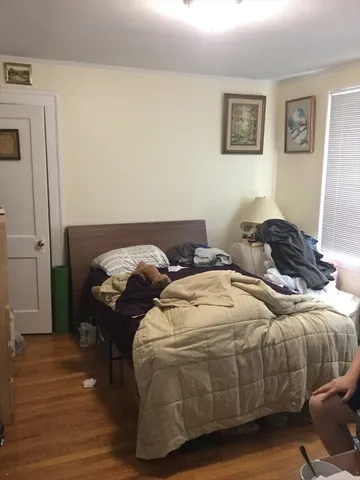 a bedroom with two beds and a painting on the wall