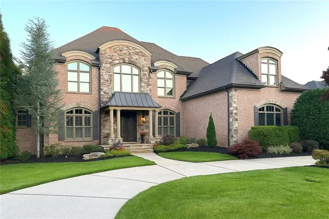 a front view of a house with a garden