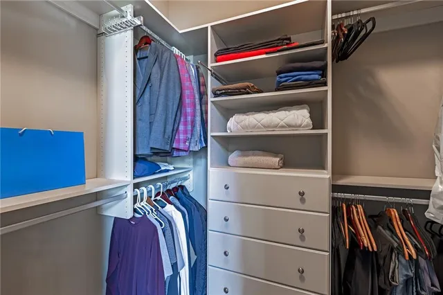 a view of a room with furniture and large windows