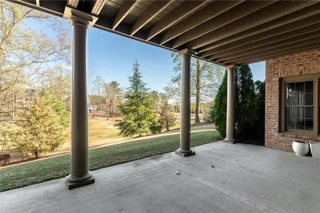 a view of a backyard with plants and lake view