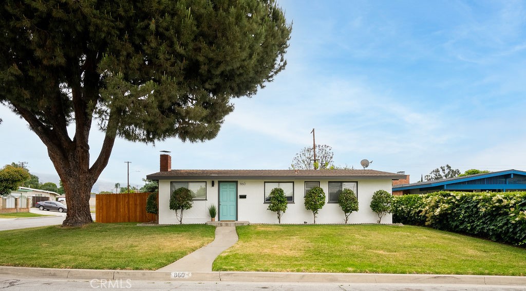 a front view of a house with a garden and yard
