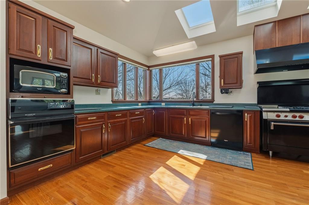 739 Butler Road Kittanning, PA 16201 - Photo 14 of 50 a kitchen with stainless steel appliances granite countertop a stove a sink dishwasher and a microwave oven with cabinets