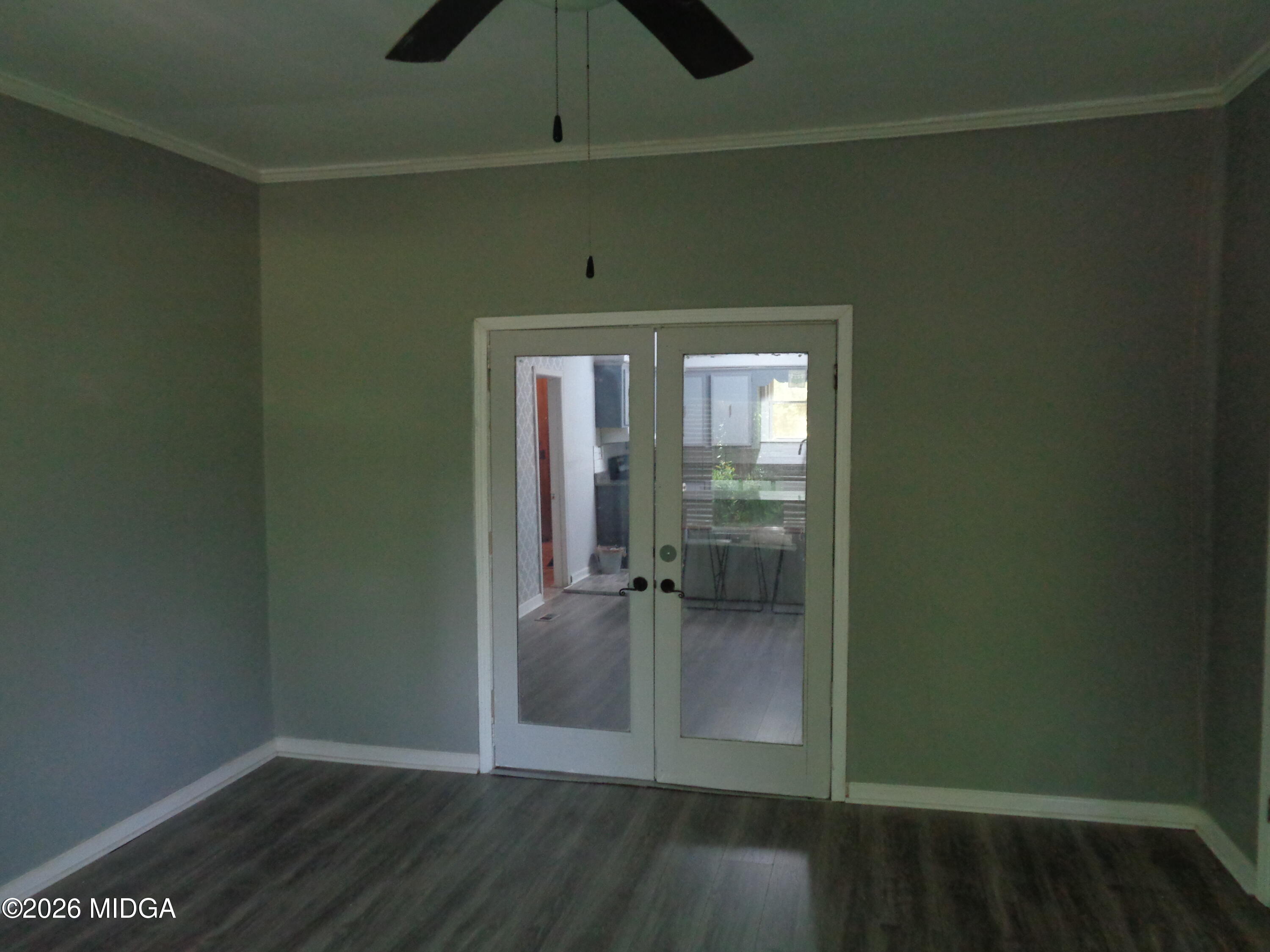 3380 Goodwin Lane Macon, GA 31217 - Photo 5 of 22 an empty room with wooden floor fan and windows