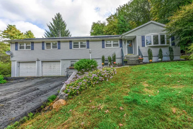 a front view of a house with a yard and porch