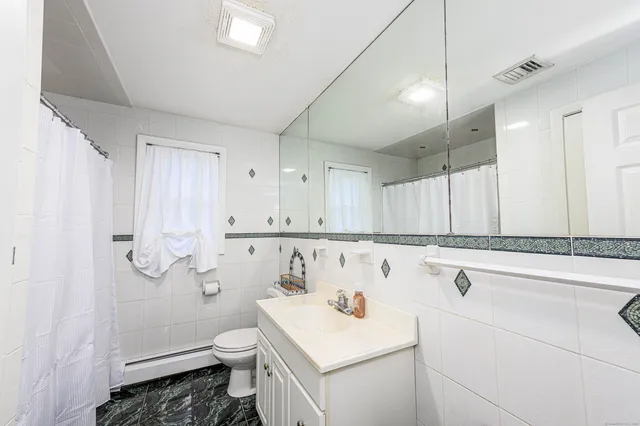 a view of bathroom with a sink and mirror