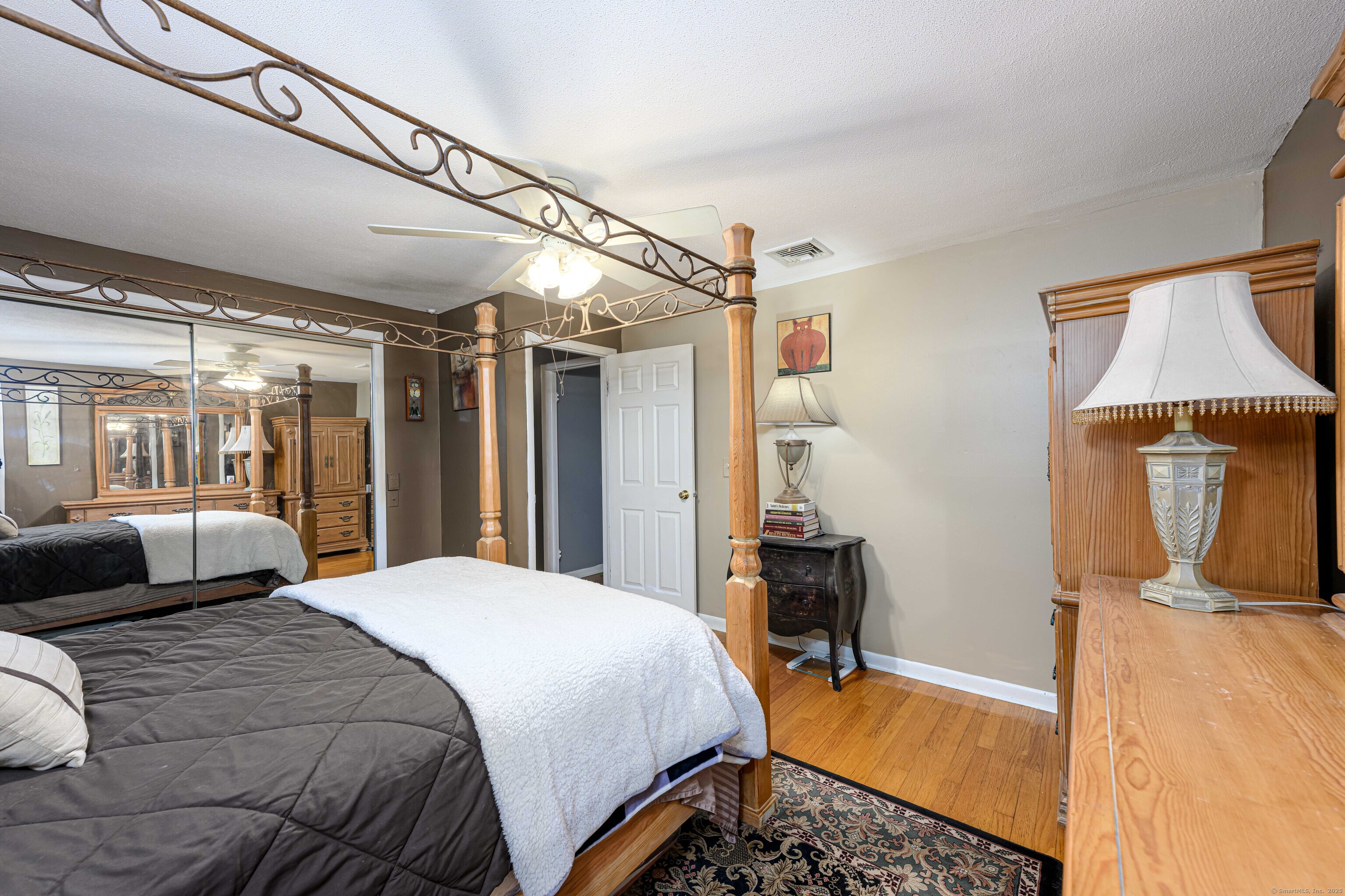 201 Rimmon Road North Haven, CT 06473 - Photo 15 of 40 a bedroom with a bed and wooden floor