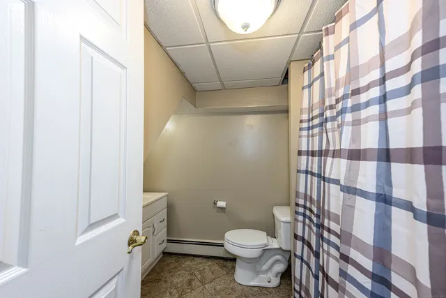 a bathroom with a toilet and a shower
