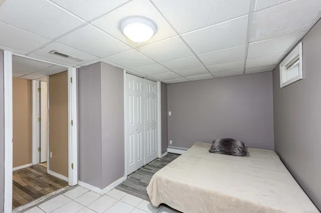 a bedroom with a bed and a rug