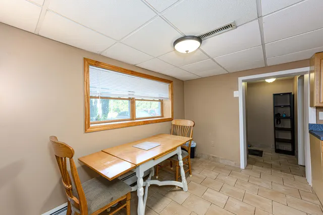 a dining room with furniture and window