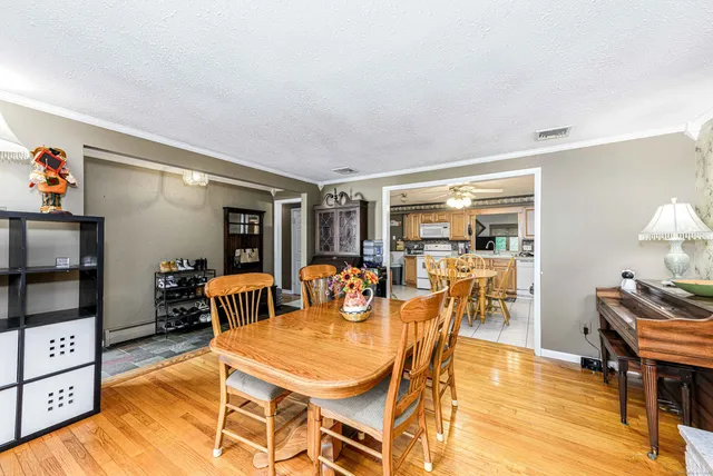 a dining room with furniture and wooden floor