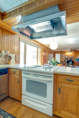 a kitchen with stainless steel appliances granite countertop a sink and a refrigerator