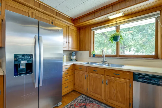 a kitchen with stainless steel appliances granite countertop a sink and cabinets