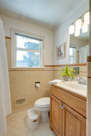 a living room with furniture a window and wooden floor