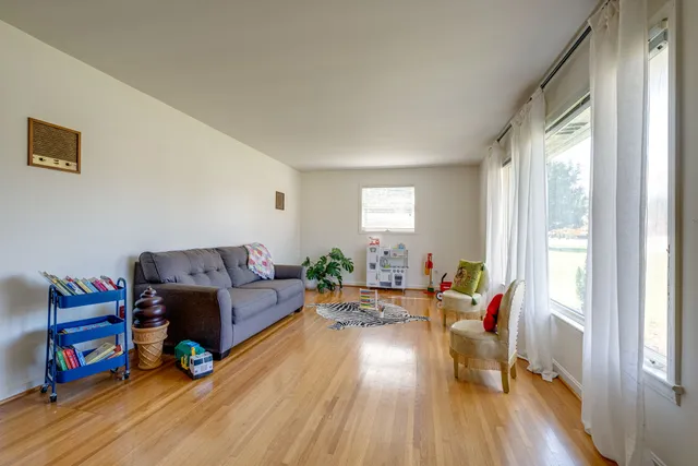a spacious bedroom with a bed and windows