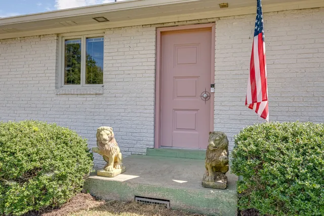 a view of a door of the house with outdoor seating