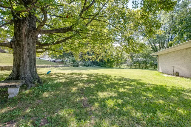 an aerial view of a house with a garden and yard