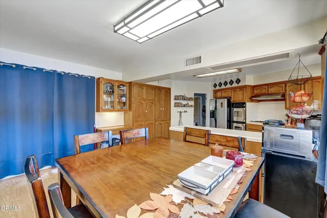 a kitchen with granite countertop cabinets stainless steel appliances and wooden floor