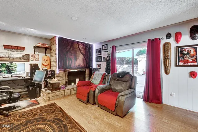 a living room with furniture a rug and white walls