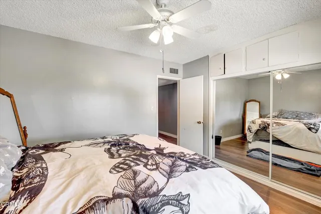 a bathroom with a granite countertop sink a large mirror and a shower