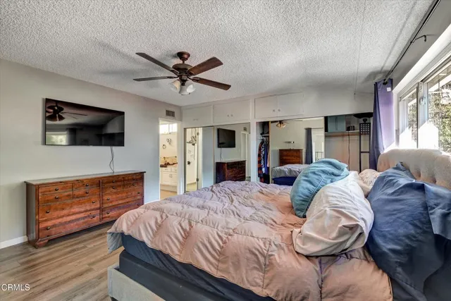 a bathroom with a granite countertop sink a mirror and shower