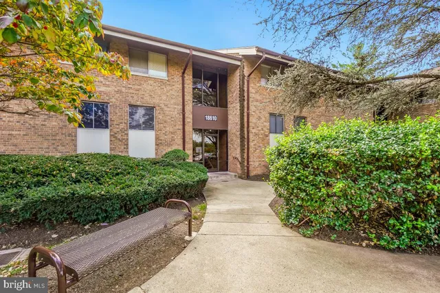 a front view of a house with a yard and fountain
