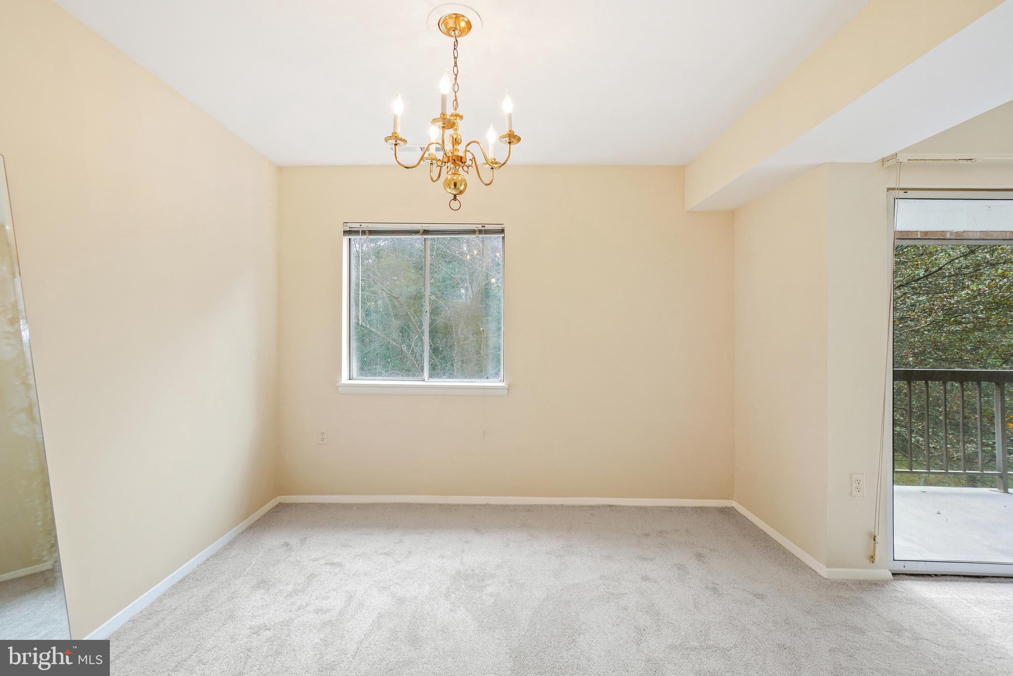 18610 Walkers Choice Road, Unit 18610 Gaithersburg, MD 20886 - Photo 14 of 30 en empty room with windows