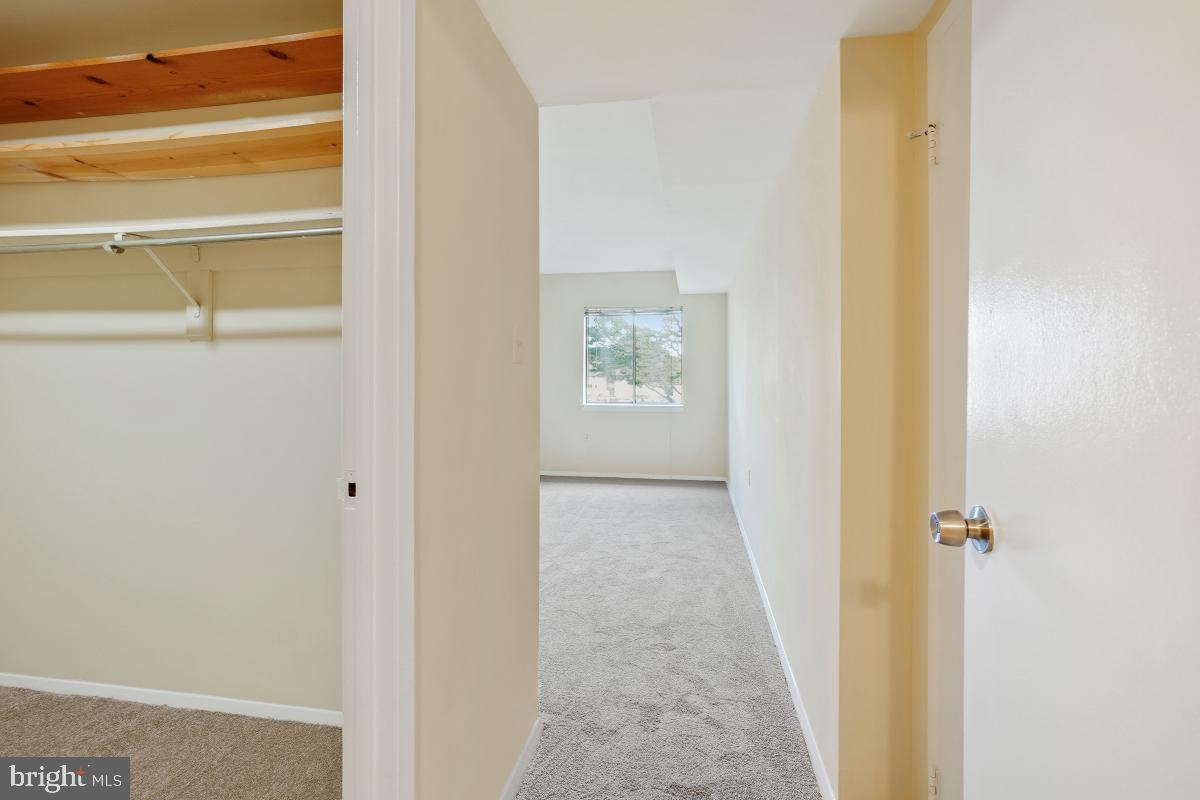 18610 Walkers Choice Road, Unit 18610 Gaithersburg, MD 20886 - Photo 23 of 30 a view of a hallway with wooden floor and a bathroom