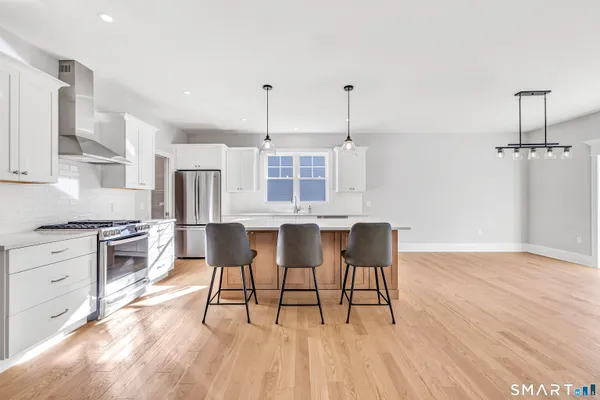 a view of a kitchen with furniture and wooden floor