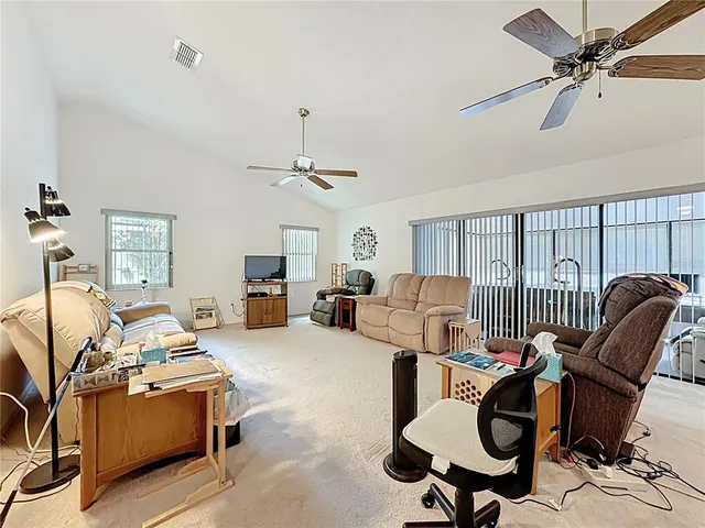 a kitchen with stainless steel appliances kitchen island granite countertop a refrigerator and microwave