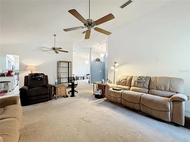 a kitchen with stainless steel appliances granite countertop a refrigerator a stove and a sink