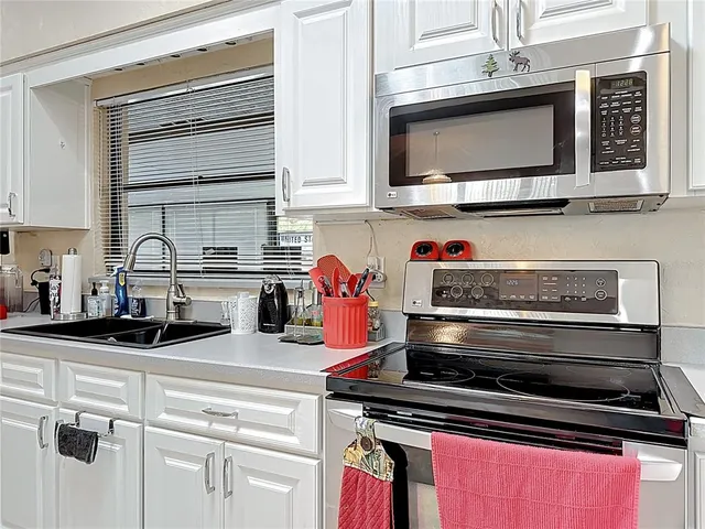 a kitchen with refrigerator and chairs