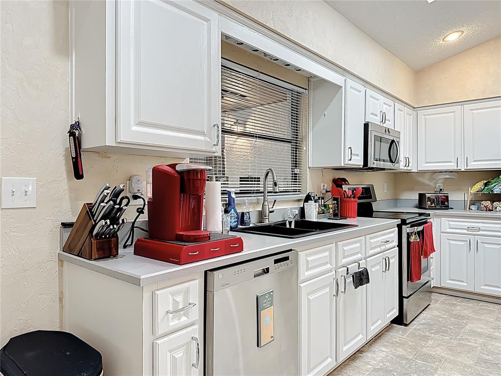 Undisclosed Address Winter Springs, FL 32708 - Photo 19 of 66 a kitchen with white cabinets and white appliances