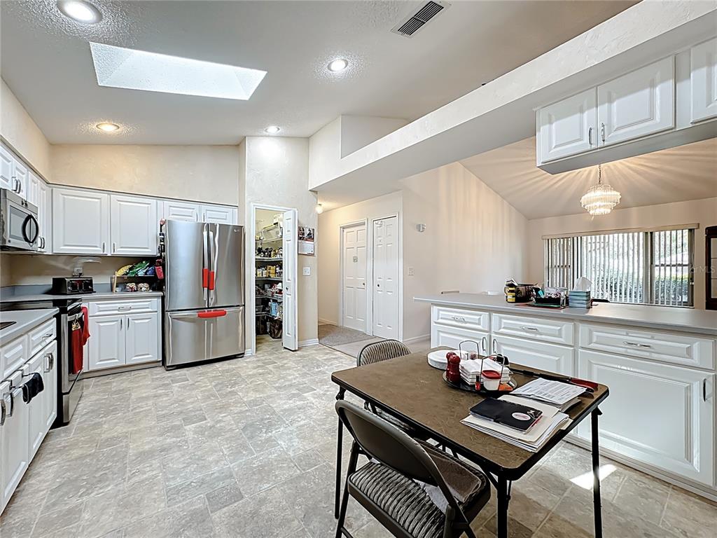 Undisclosed Address Winter Springs, FL 32708 - Photo 21 of 66 a kitchen with refrigerator and chairs