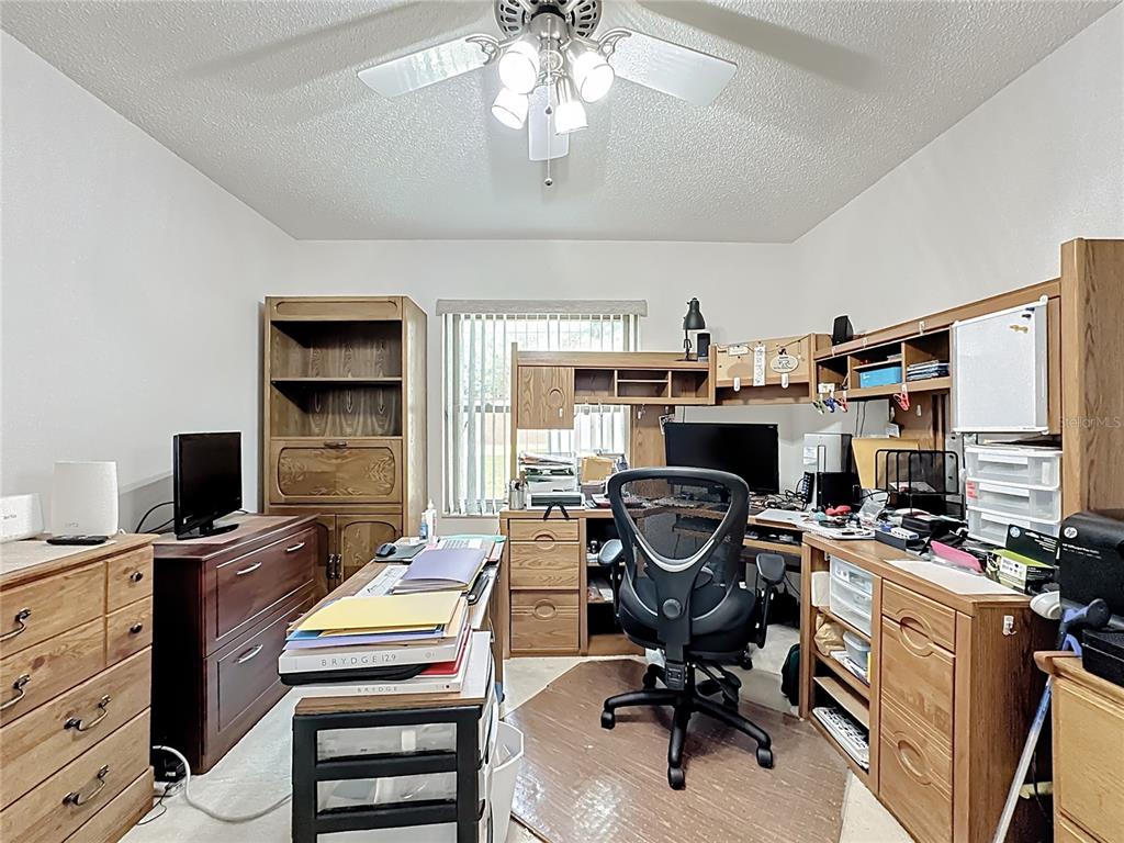 Undisclosed Address Winter Springs, FL 32708 - Photo 41 of 66 a view of a workspace with furniture and a ceiling fan