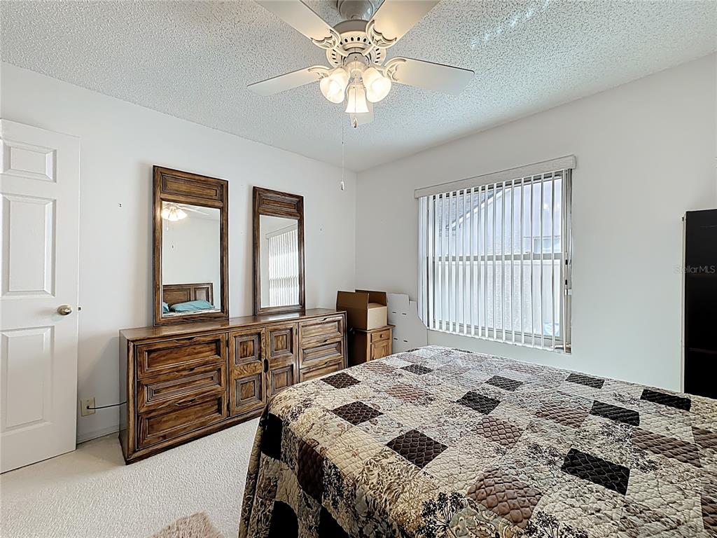 Undisclosed Address Winter Springs, FL 32708 - Photo 44 of 66 a bedroom with a bed and a dresser next to a window