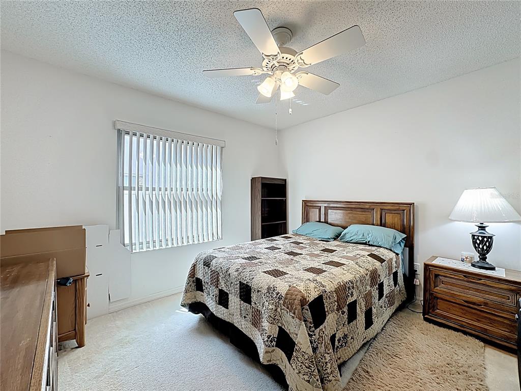 Undisclosed Address Winter Springs, FL 32708 - Photo 45 of 66 a bedroom with a bed and a chandelier