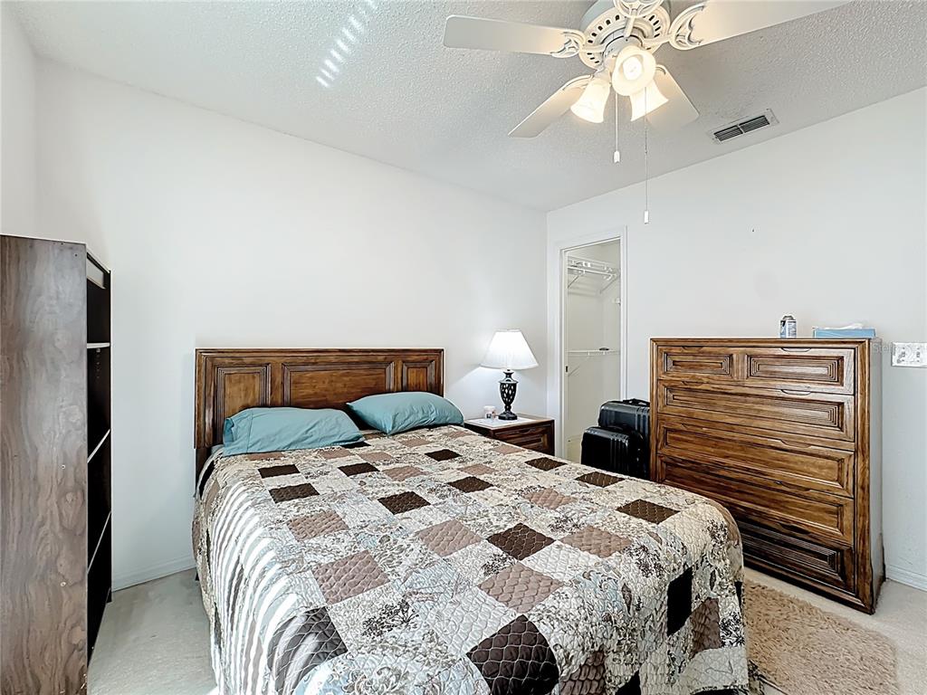 Undisclosed Address Winter Springs, FL 32708 - Photo 46 of 66 a bedroom with a bed and a chandelier