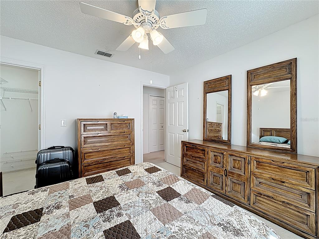 Undisclosed Address Winter Springs, FL 32708 - Photo 47 of 66 a bedroom with a bed and a dresser