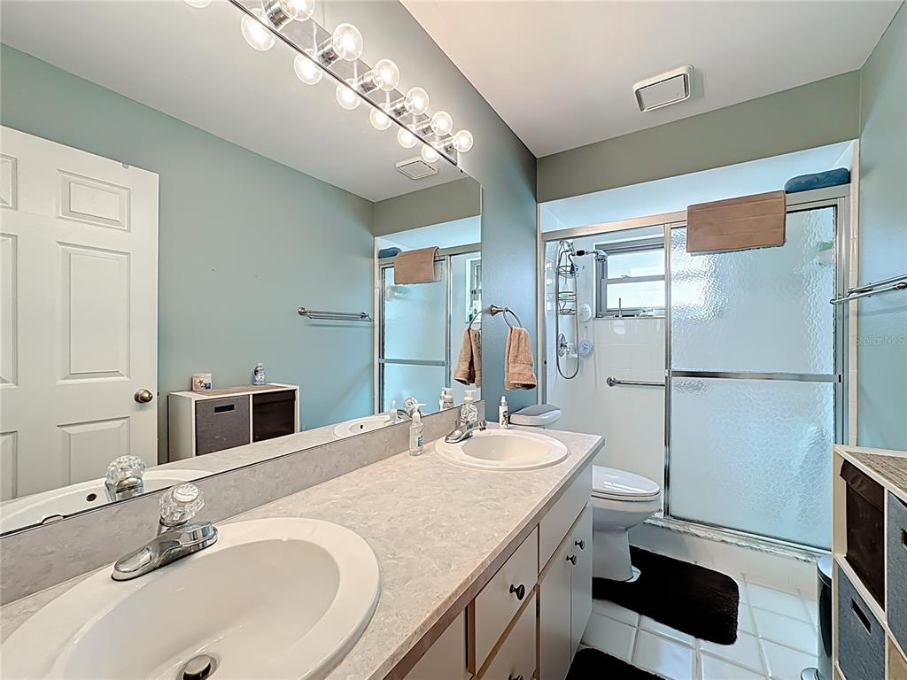 Undisclosed Address Winter Springs, FL 32708 - Photo 48 of 66 a bathroom with a double vanity sink and a mirror