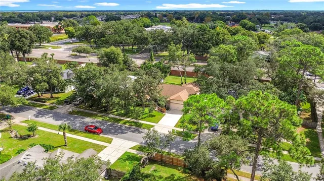 a view of a patio with furniture and a garden
