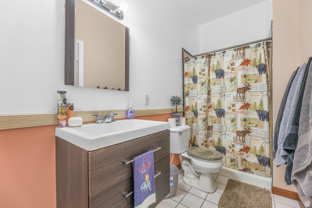 569 Elk Meadow Loop Tooele, UT 84074 - Photo 38 of 56 Bathroom featuring vanity, a shower with curtain, and light tile patterned floors