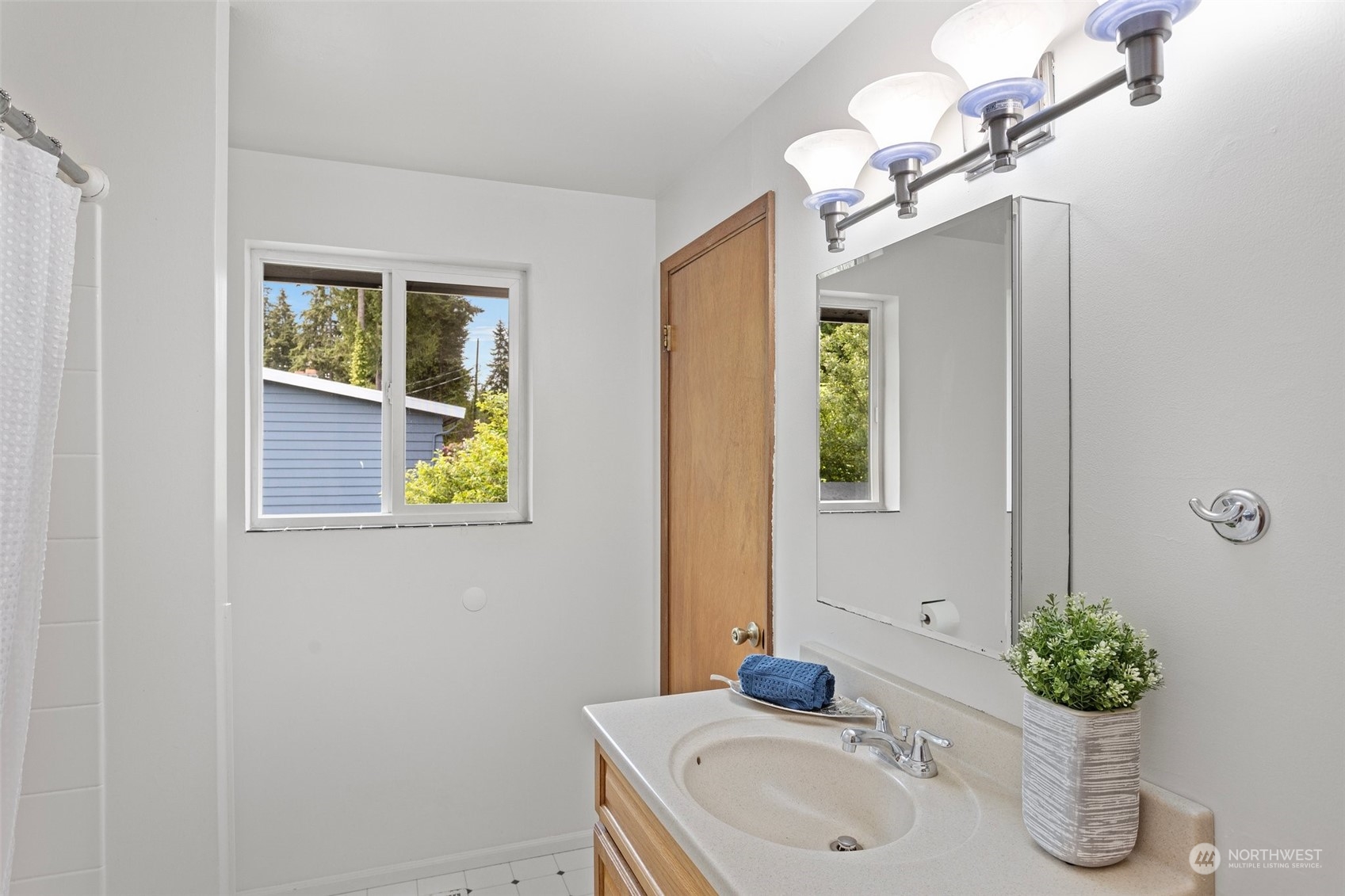 331 North 200th Street Shoreline, WA 98133 - Photo 12 of 28 a bathroom with a sink and a mirror