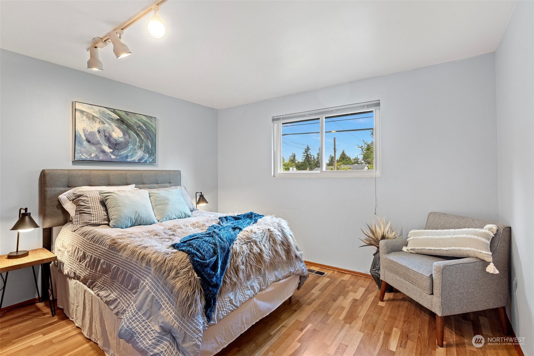 331 North 200th Street Shoreline, WA 98133 - Photo 14 of 28 a bedroom with a bed and wooden floor