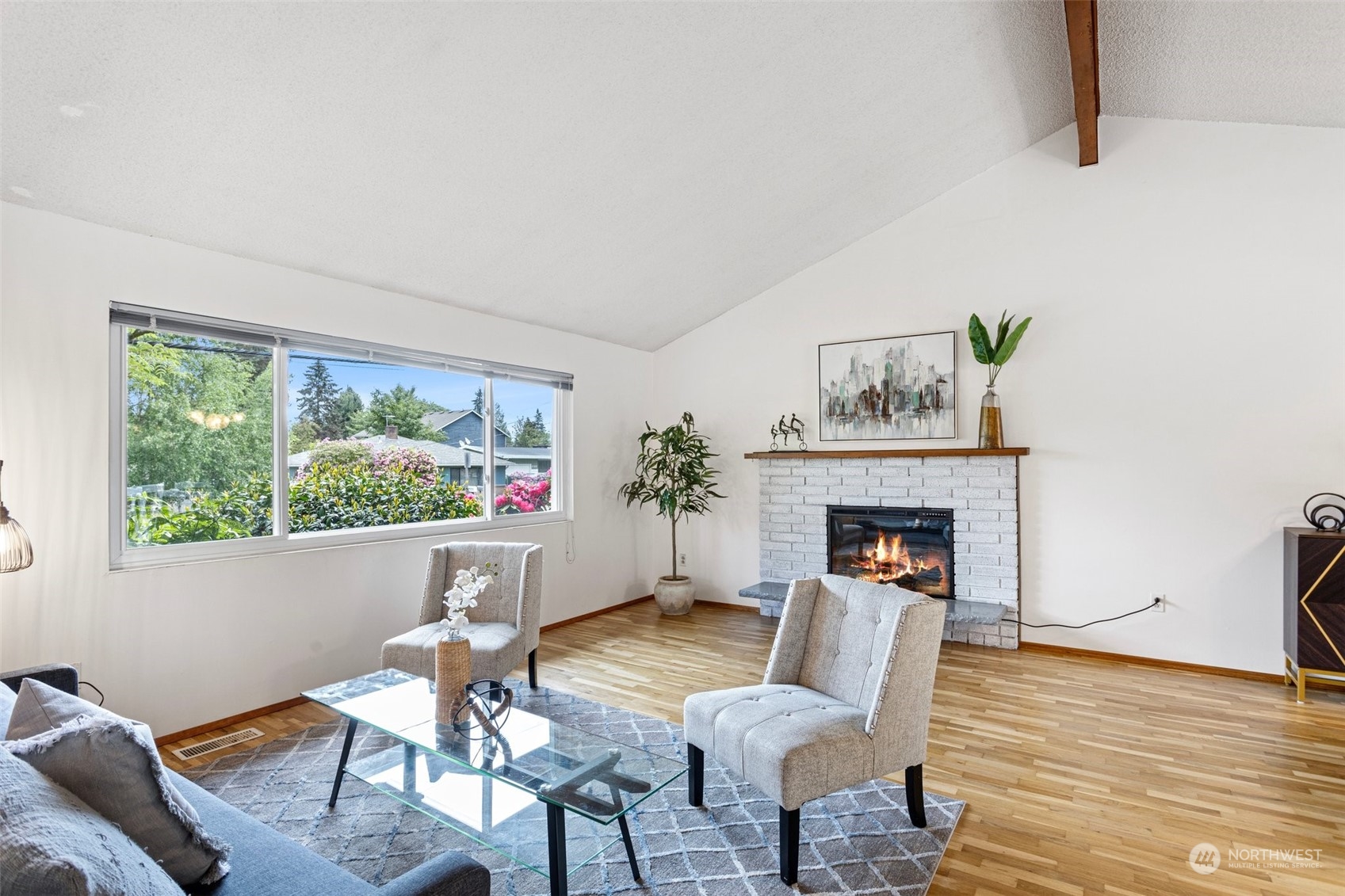 331 North 200th Street Shoreline, WA 98133 - Photo 3 of 28 a living room with furniture a fireplace and a large window