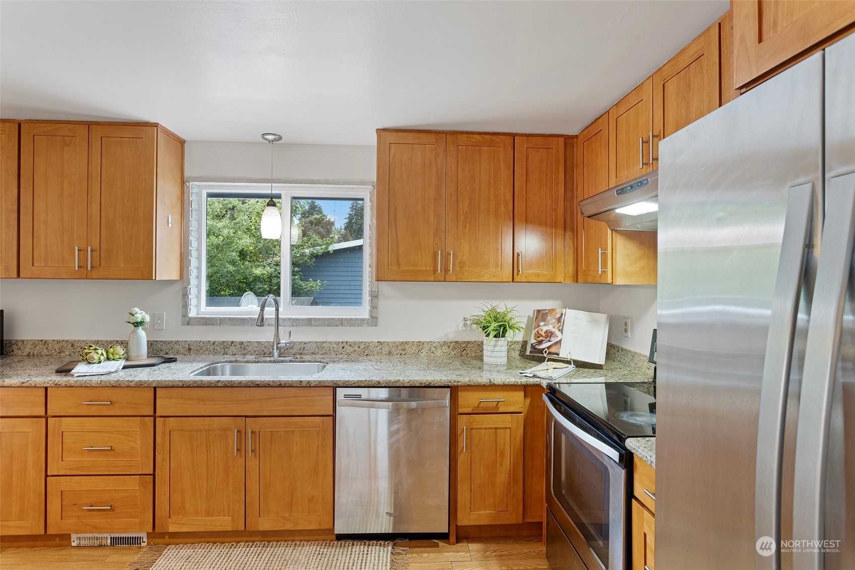 331 North 200th Street Shoreline, WA 98133 - Photo 9 of 28 a kitchen with stainless steel appliances granite countertop a sink stove and refrigerator