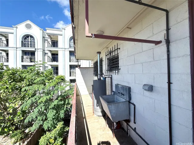a view of balcony with two chairs and a potted plant