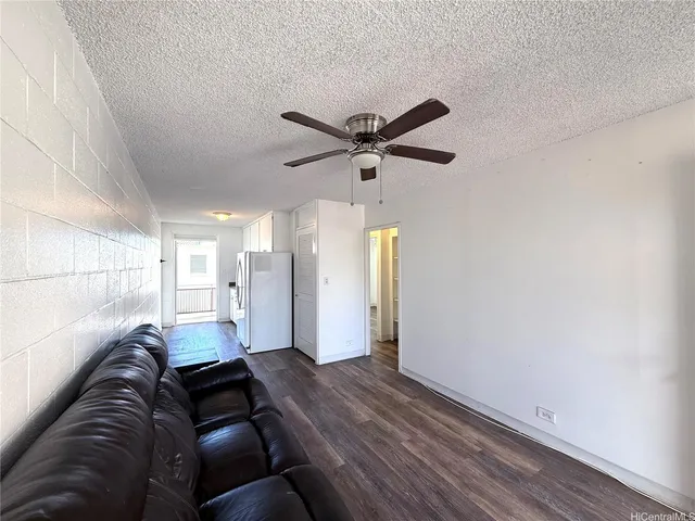 a living room with furniture and a ceiling fan